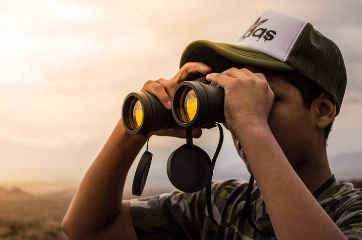 Man looking in binoculars