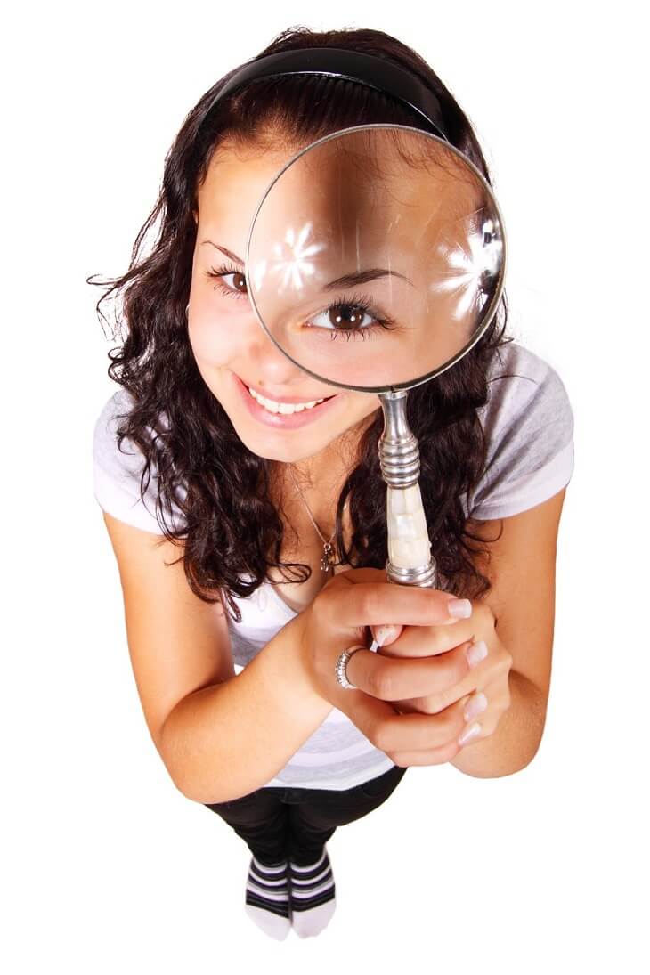 woman holding magnifying glass